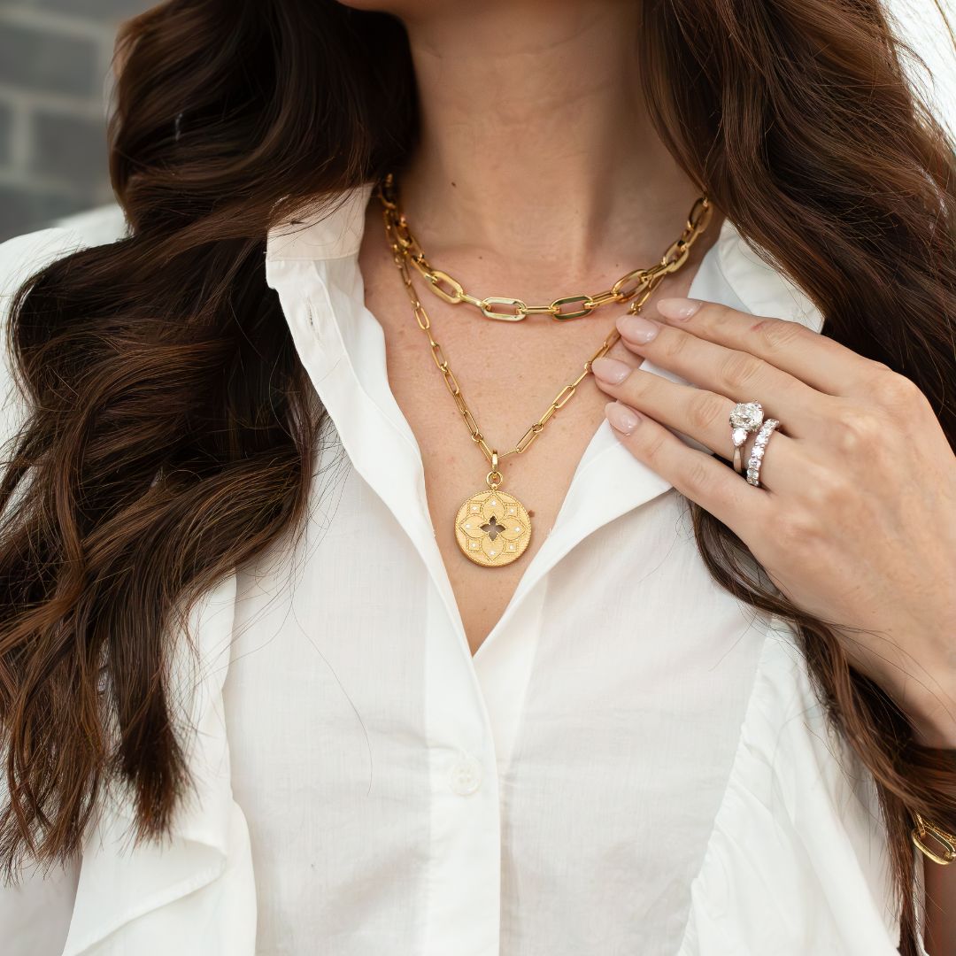 Woman wearing gold layered necklaces