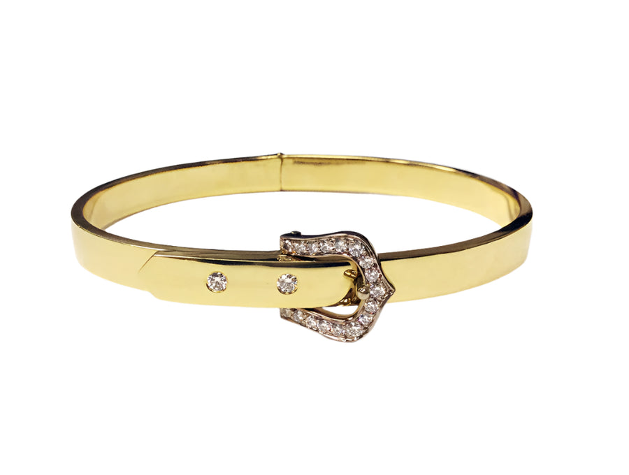 Gold bracelet with a diamond buckle on a white background