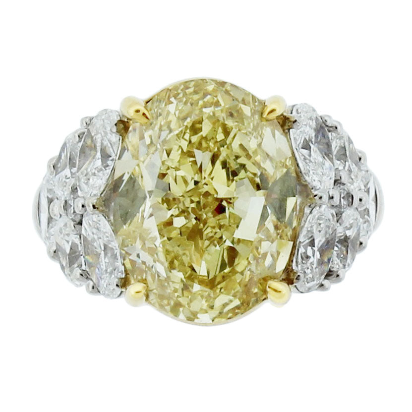 Platinum Ring with 7.01ct Fancy Brownish Yellow Oval Diamond, 2.30ct Oval Diamonds, and 0.06ct Fancy Cut Diamonds, Size 5.75